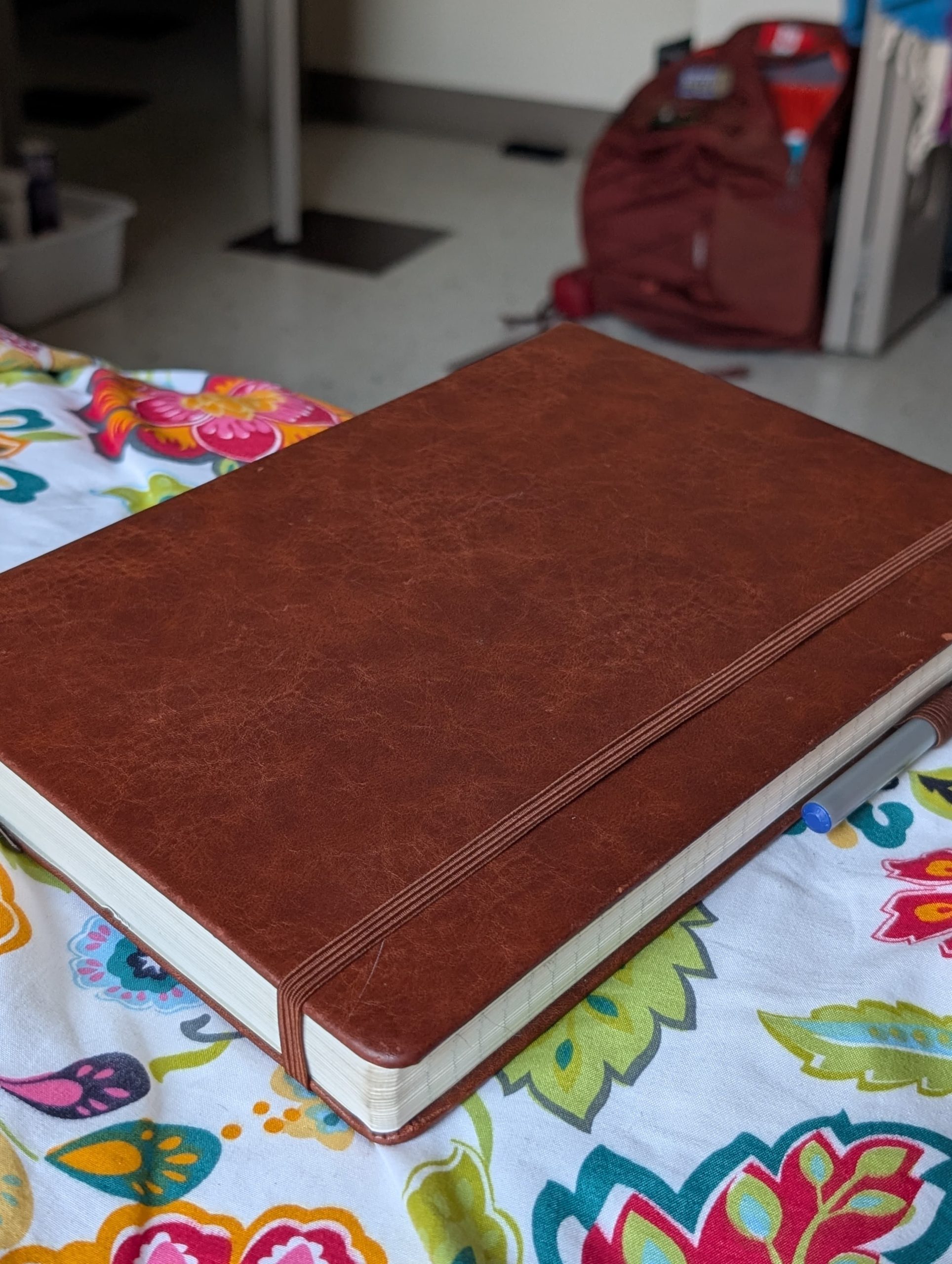 Grateful Journal on floral sheet with backpack — daily gratitude practice
